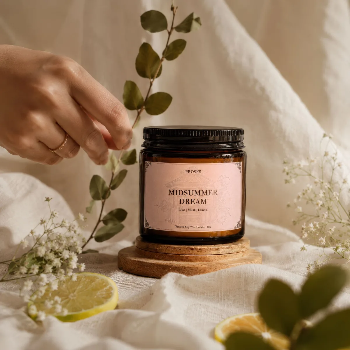 Midsummer Dream candle styled with linen, flowers, and citrus