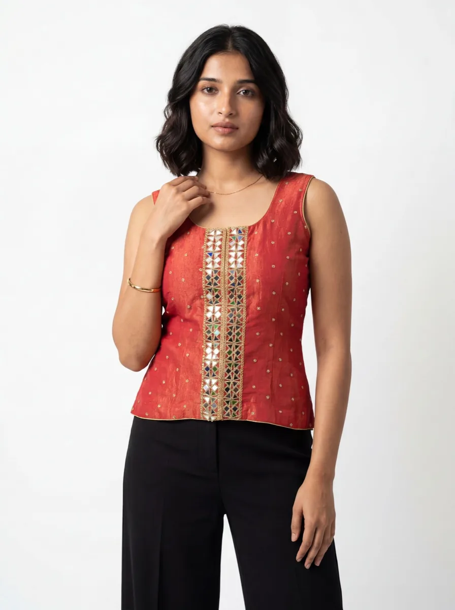 AI model wearing a red embellished garment on a white background